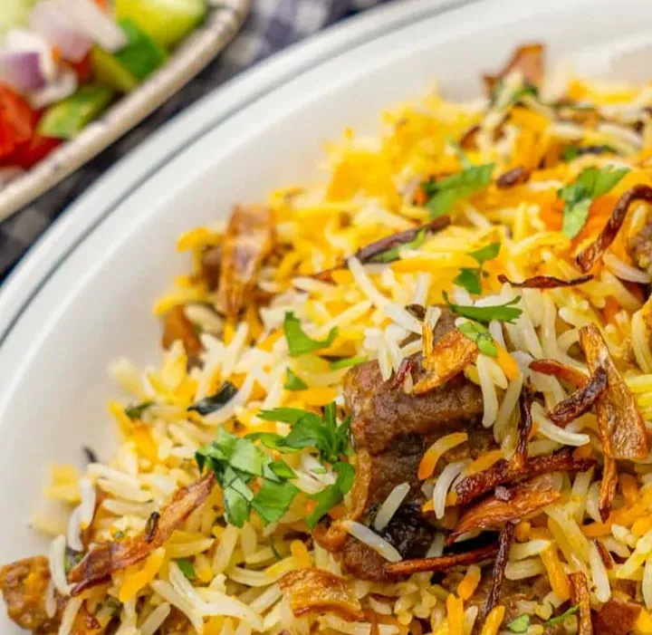 Fragrant dum-style Lamb Biryani with basmati rice at Rawaayt Indian restaurant in Ellerslie, Edmonton